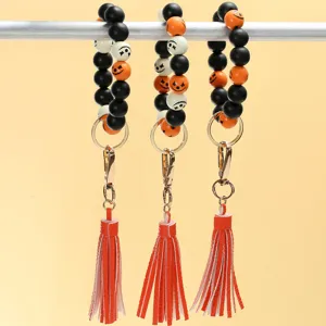 Halloween beaded wristlet keychain with colorful wood beads, metal clasp and leather tassel.
