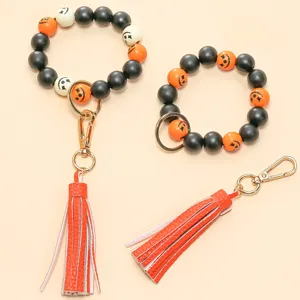 Halloween beaded keychain bracelet with leather tassel, cute pumpkin wood beads wristlet.