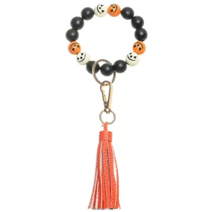 Halloween wooden bead wristlet keychain detail, featuring colorful beads and leather tassel.