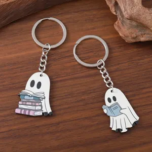 Cute reading ghost keychain detail, wooden cartoon pendant close-up view for keys.