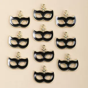 Close-up of black enamel masquerade mask alloy pendant, perfect for DIY jewelry making.