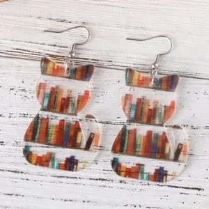 Detailed view of cute acrylic cat bookshelf earrings, unique book lover jewelry for daily wear.