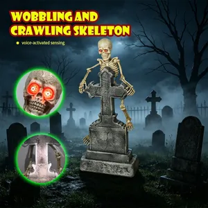 Detail of voice-activated crawling skeleton on tombstone with glowing red eyes for Halloween.