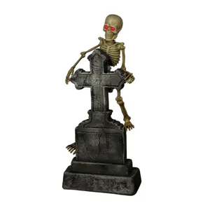 Halloween glowing tombstone skeleton prop with red LED eyes for spooky haunted house decor.