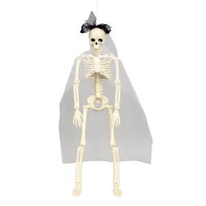 Detailed shot of Halloween plastic skeleton bride hanging prop with white veil and black bow.