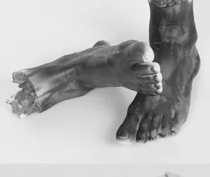 Detail shot of Halloween bloody severed feet props, horror party scene decor for haunted house.