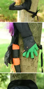 Halloween tree climbing witch decoration detail shot, spooky holiday outdoor hanging prop.