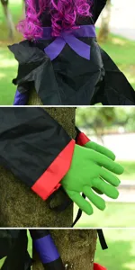 Close up detail of Halloween tree hugging witch decoration featuring purple hair and green hands.
