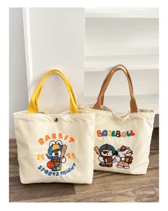 Corduroy tote bag with cute cartoon embroidery, large capacity bento handbag for women.
