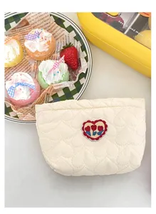 Quilted cosmetic pouch cute tulip embroidery portable sanitary napkin storage makeup bag.