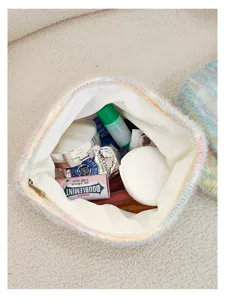 Cozy knitted fuzzy cosmetic pouch detail showing spacious interior storage and soft feel.