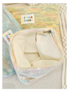 Knit plush cosmetic pouch detail shot, soft texture zippered mini handbag and coin purse.