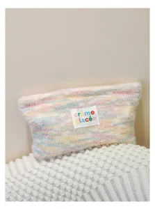 Knit plush cosmetic pouch with pastel stripes and cute text label for daily makeup storage.