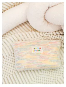 Cozy pastel knit cosmetic bag with plush texture and cute label, perfect for daily portable storage.