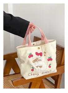 Detailed close-up view of the cute rabbit embroidered corduroy tote bag with pink handles.