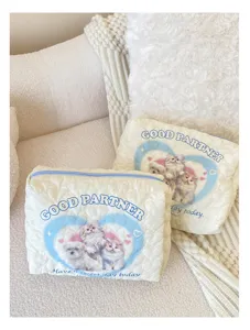 Close-up detail of quilted cosmetic storage bag showcasing cute pet print and soft fabric.