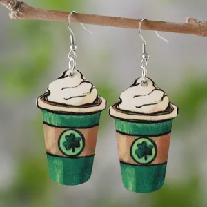 Nahaufnahme Detail von gruenen Kaffeetasse Holzohrenringen mit Kleeblatt fuer St Patricks Day.