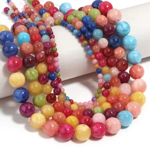 Perles rondes en pierre précieuse pour bijoux DIY, surface lisse et détails aux couleurs vives.