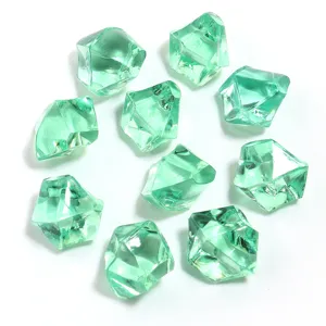 Close-up detail of green acrylic simulated ice stones, transparent crystal irregular craft decor.