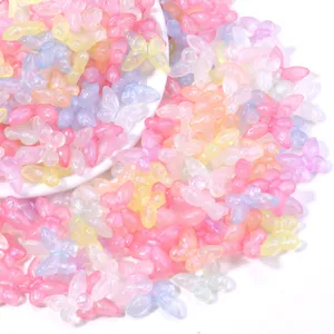 Detailed close-up of colorful iridescent acrylic butterfly beads for DIY jewelry making and crafts.