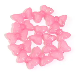 Pink acrylic glitter bow beads detail view, perfect for DIY jewelry crafting and accessories.
