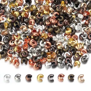 Assorted metallic C-shaped crimp beads and spacer beads for DIY handmade jewelry crafting.
