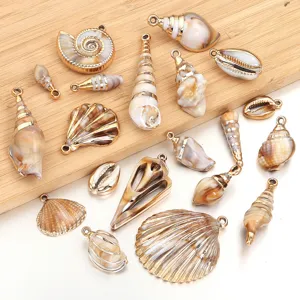 Detailed view of assorted beige acrylic gold-plated shell charms, perfect for DIY jewelry making.
