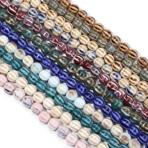 Detailed view of colorful glazed ceramic striped pumpkin beads, perfect for DIY jewelry making.