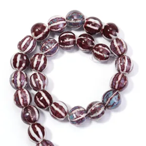 Close-up detail of glazed ceramic striped round beads for DIY jewelry making and craft projects.