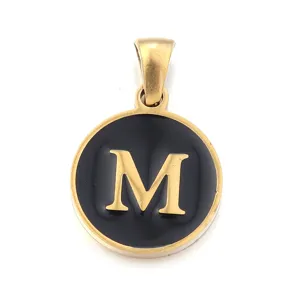 Detailed close-up of a stainless steel round pendant featuring a black enamel and letter M.