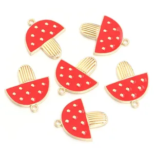 Detailed view of red enamel mushroom alloy pendants, perfect for DIY jewelry making and crafts.