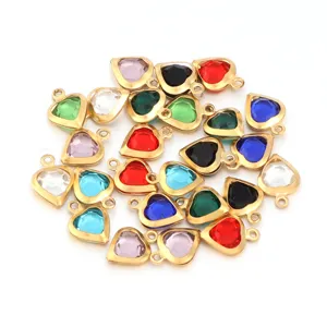 Colorful crystal heart pendants with metal edging, perfect for DIY jewelry crafting details.