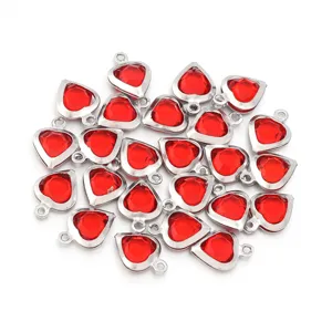 Detailed view of red crystal heart charms with silver bezels, ideal for DIY jewelry projects.