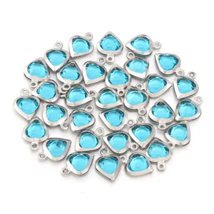 Blue crystal heart pendants close up, steel bezel charm DIY jewelry making accessories.