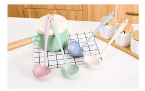 Detailed view of wheat straw plastic soup spoons in multiple colors on kitchen counter.