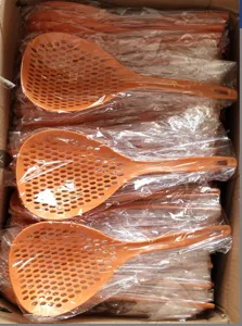 Grande écumoire de cuisine orange en nylon avec des trous fins et un long manche.