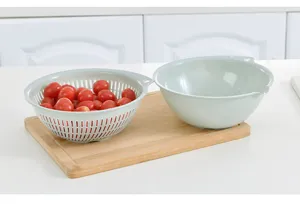 Colador y bol de plástico de doble capa, ideal para lavar frutas y verduras en la cocina.