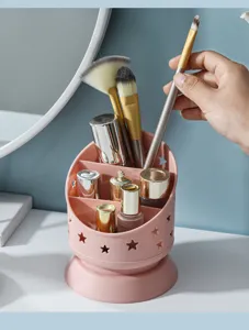 Organisateur de bureau rose en plastique porte-stylo avec des découpes d'étoiles.