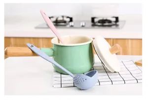 Detailed view of kitchen wheat straw long handle soup spoon and colander set with milk pan.
