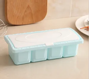 Four-grid plastic seasoning box with lid, clean kitchen storage container for spices.