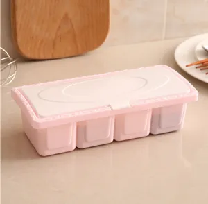 Plastic 4-grid seasoning box with dustproof lid, ideal for kitchen spice storage and organization.