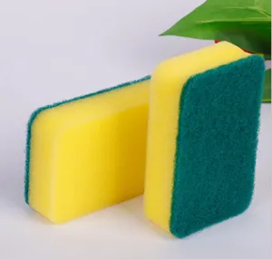 Detail view of the dual-sided cleaning sponge featuring absorbent yellow foam and green scouring pad.