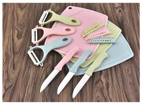 Ceramic kitchen knife set with peelers and cutting boards, practical kitchen tool set.