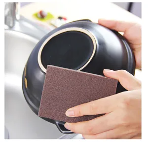 Carborundum cleaning sponge for heavy duty kitchen pot and pan rust stain removal tool.