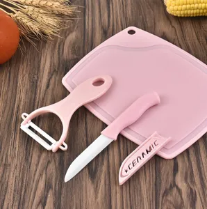 Pink ceramic fruit knife set with peeler and cutting board kitchen three piece tool kit.