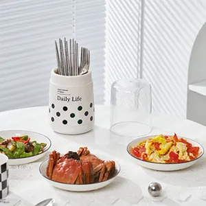 Porte-baguettes cylindrique blanc moderne avec des pois et un couvercle pour le rangement de cuisine.