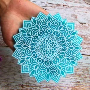 Close-up detail of the blue mandala resin mold, showing intricate white geometric pattern.