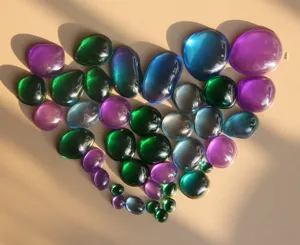 Detailed view of colorful irregular round resin gemstone drops in beautiful arrangement.