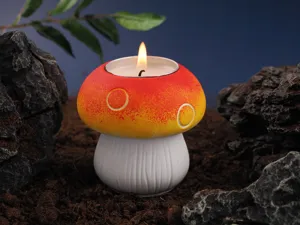 Closeup shot of the mushroom scented candle in a natural soil and rock scene with warm flame.