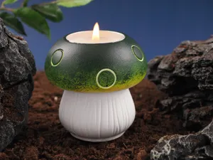 Handmade mushroom shaped scented candle holder with green cap and white base for home decor.